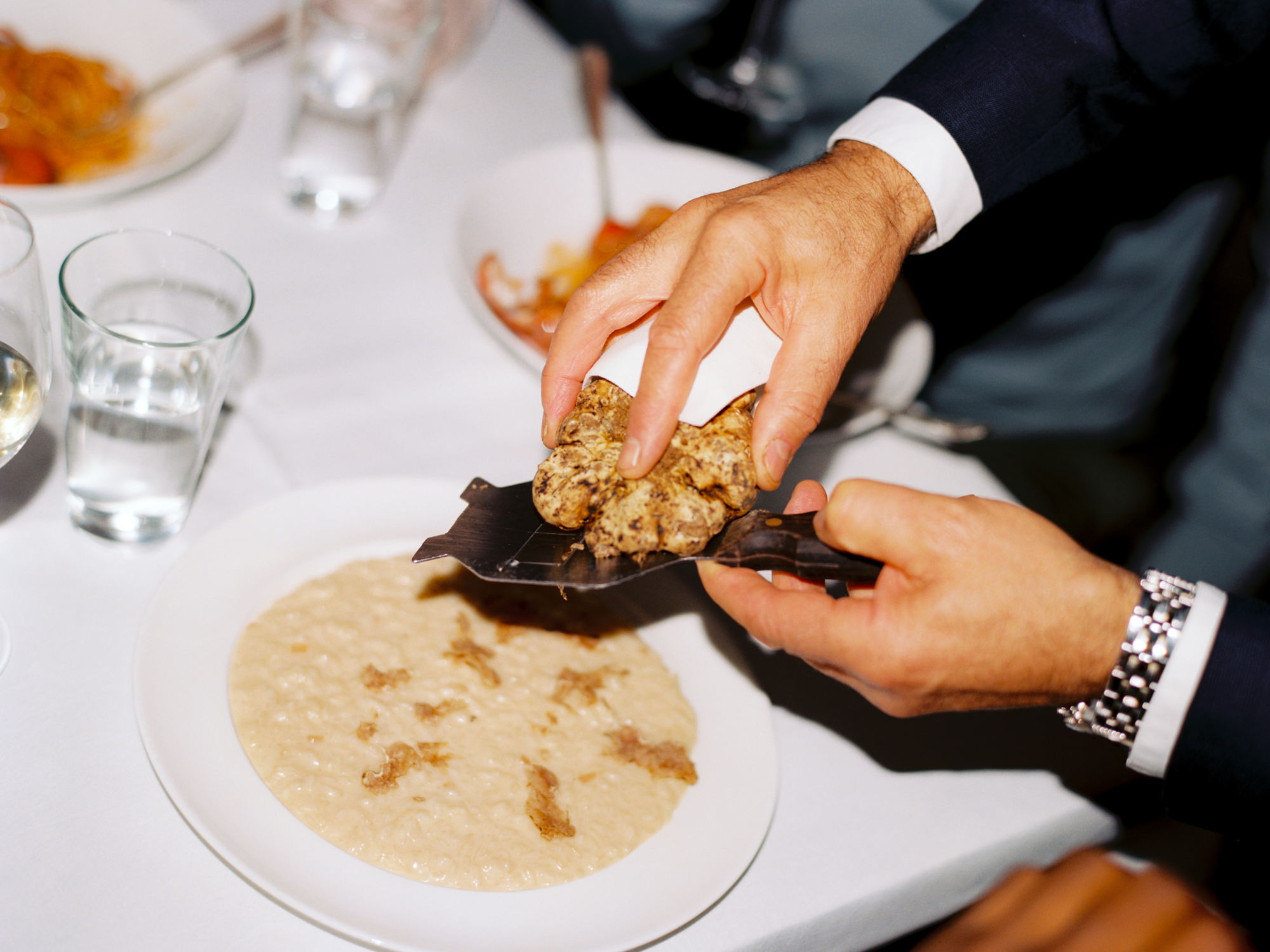 A waiter serving a dish