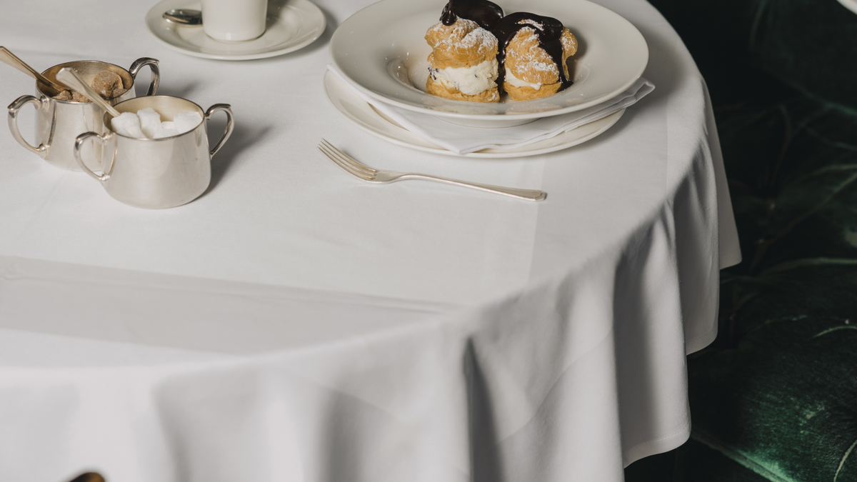 A waiter serving a dish